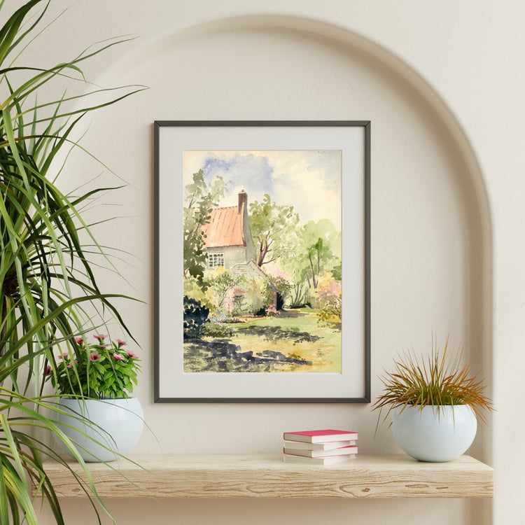 Framed and mounted print of a Provence cottage in trees hanging in an arched alcove