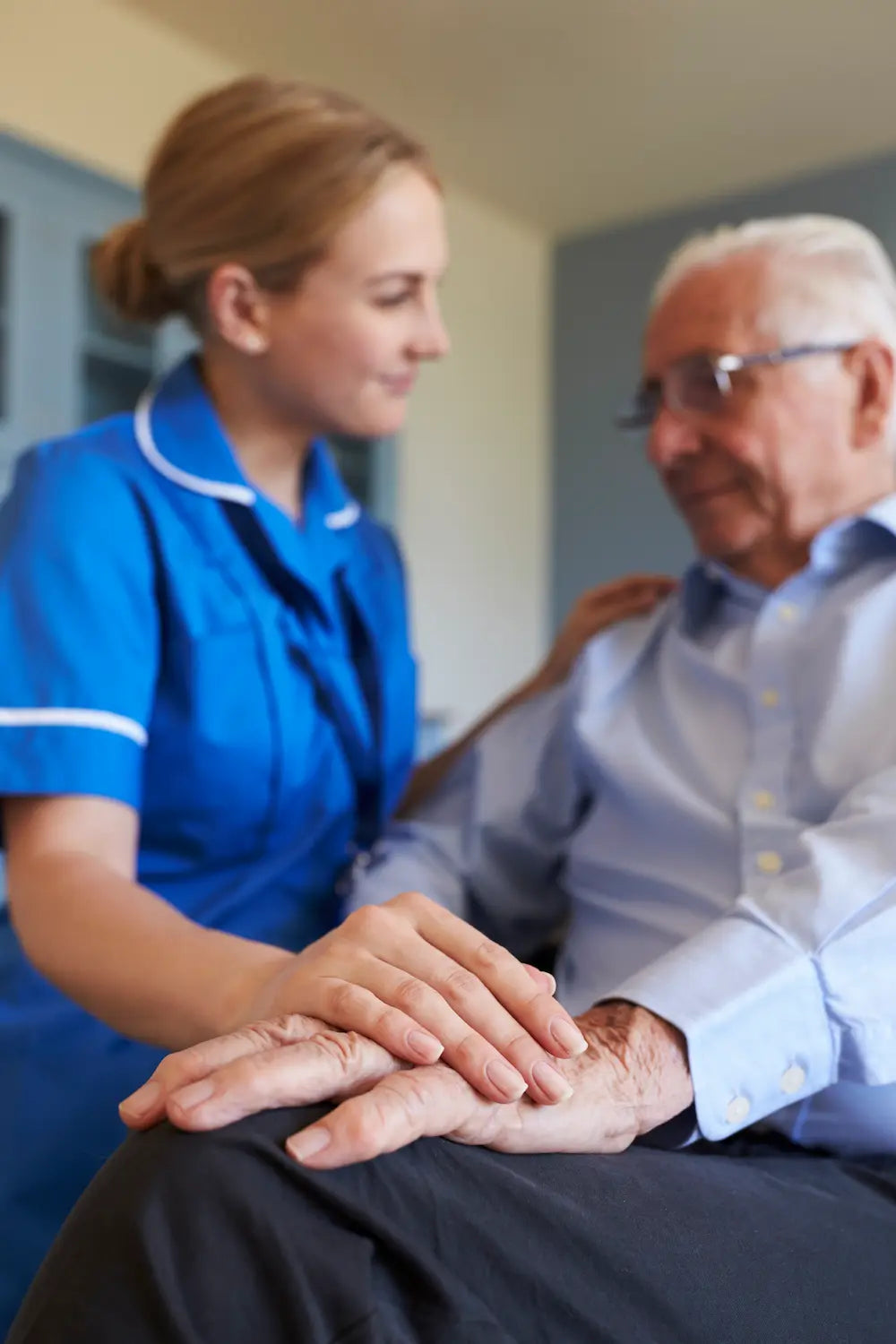 A nurse comforting an elderly man